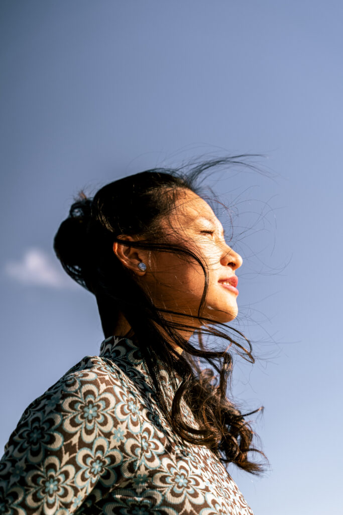 Woman looking out with hair blowing